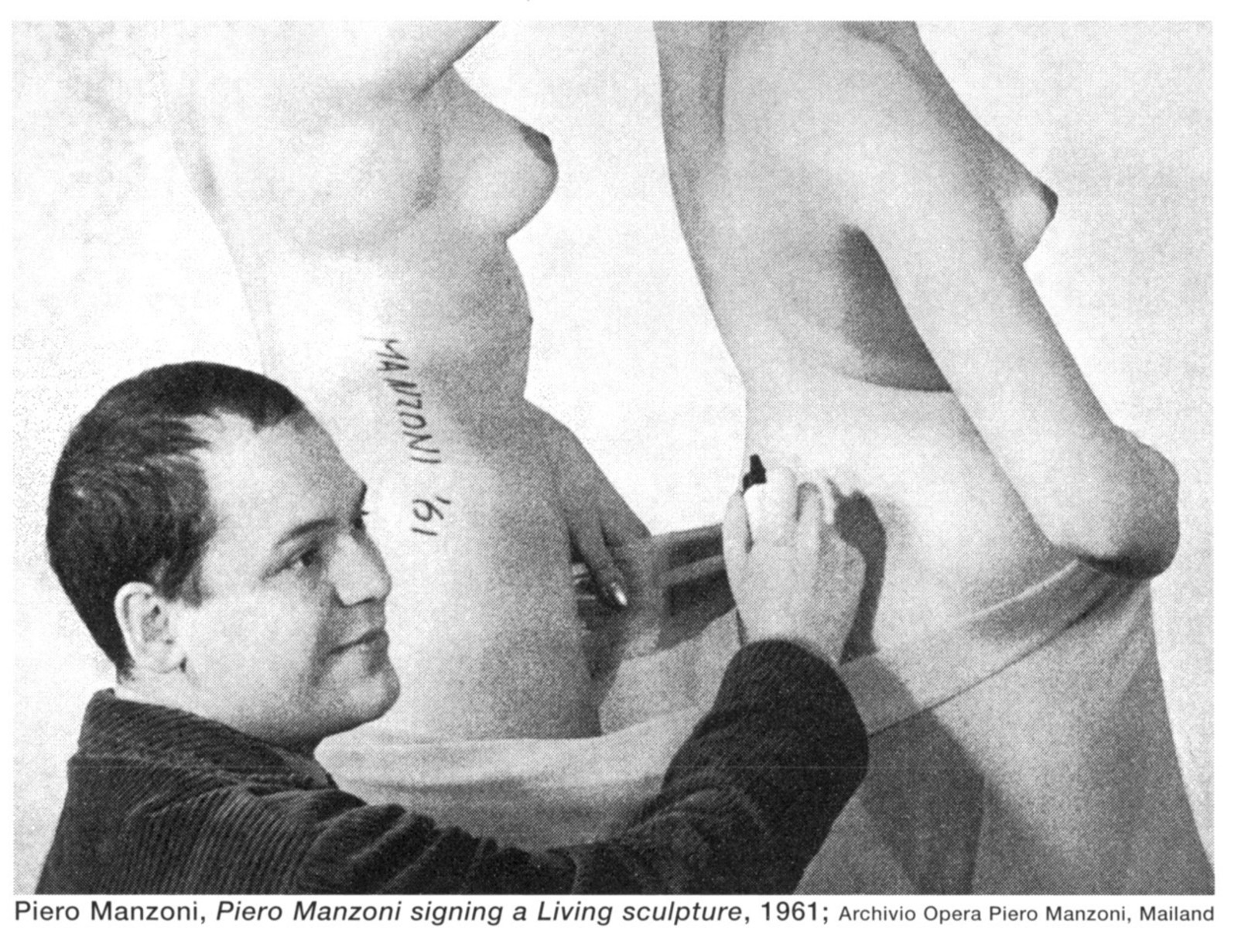 Piero Manzoni. Living Sculpture. 1961. Galleria La Tartaruga (Rome, Italy). Photo: Piero Manzoni signs a living sculpture. Private archive of Piero Manzoni.