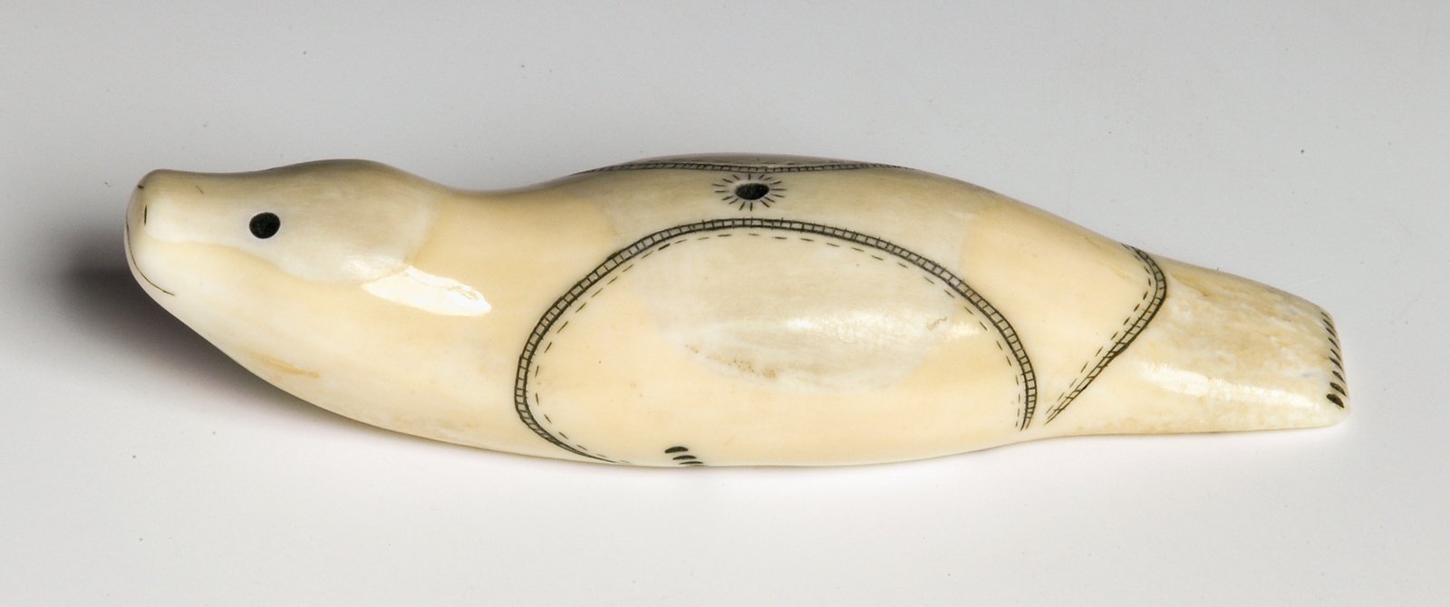 Oleg Kalyach. Seal. 1987Uelen, ChukotkaWalrus tusk, carving, engraving. Length 9 cmState Museum of Oriental Art