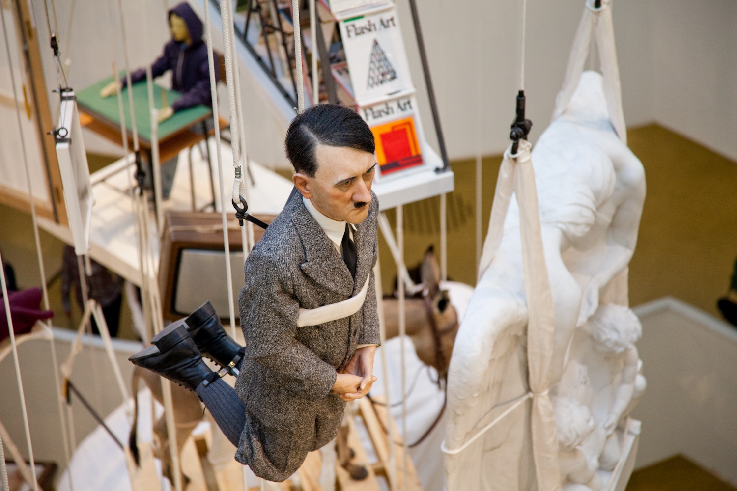Maurizio Cattelan. Praying Hitler. 2012. Wax, pigment, human hair, fabric, polyester resin. Warsaw Ghetto (Warsaw, Poland).
