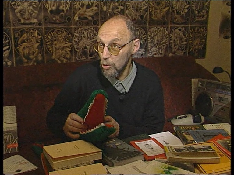 Интервью Дмитрия Александровича Пригова из цикла телепередач «Классики современного искусства». Арт медиа центр «TV Галерея» по заказу телеканала «Культура». 2002Кадр из видеоФонд Нины Зарецкой (Арт медиа центр «ТV Галерея»), архив Музея современного искусства «Гараж»