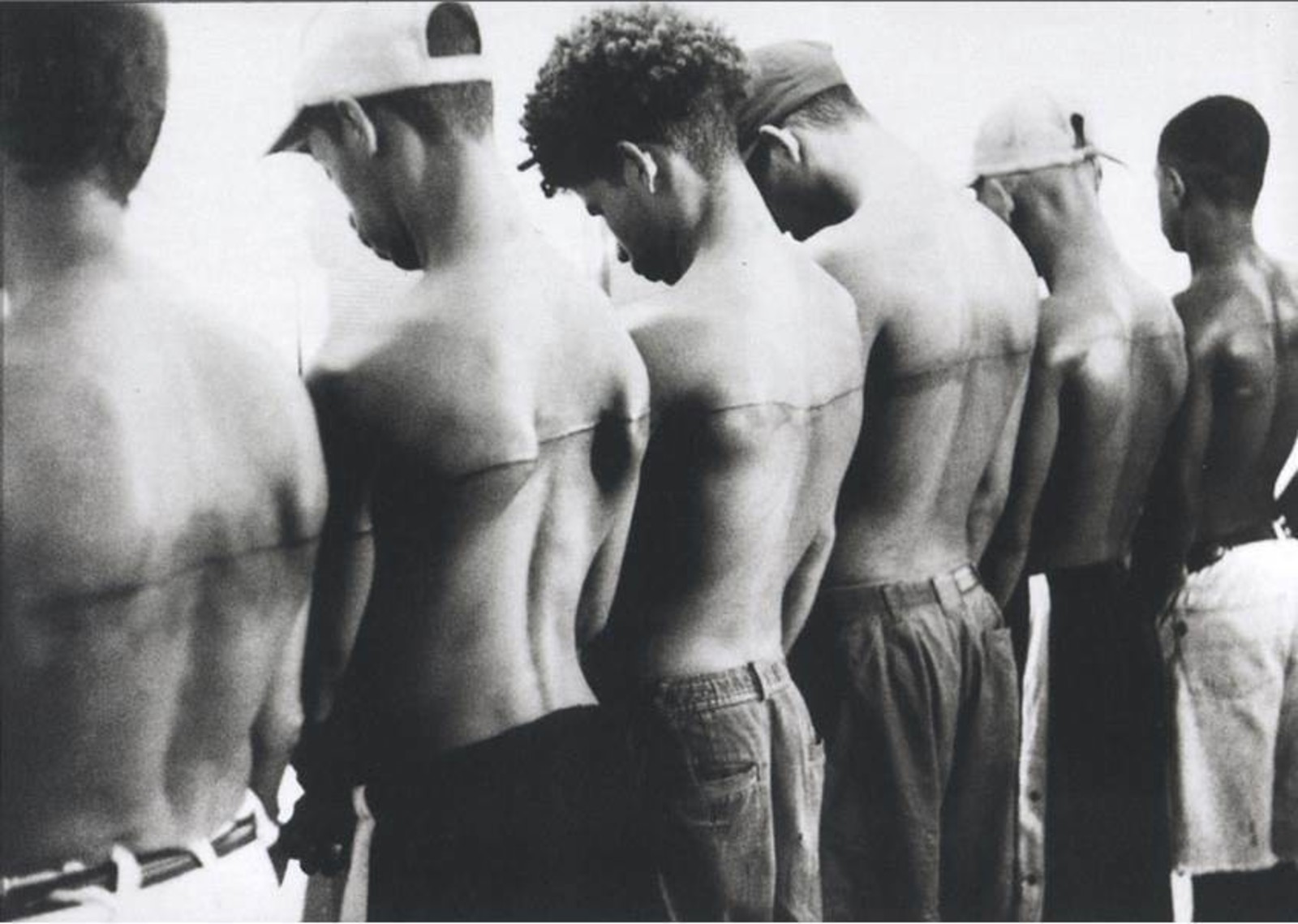 Santiago Sierra. Line. 1999. Tattoo across the backs of six people. 250 cm