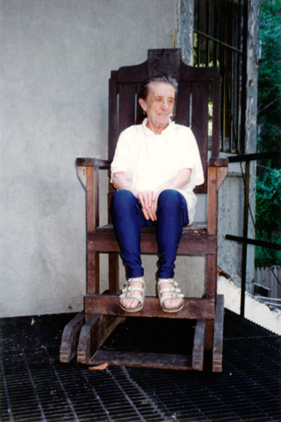 Louise Bourgeois at home in 1995 sitting in the electric chair later used in Passage Dangereux (1997) Photo: &copy; The Easton Foundation