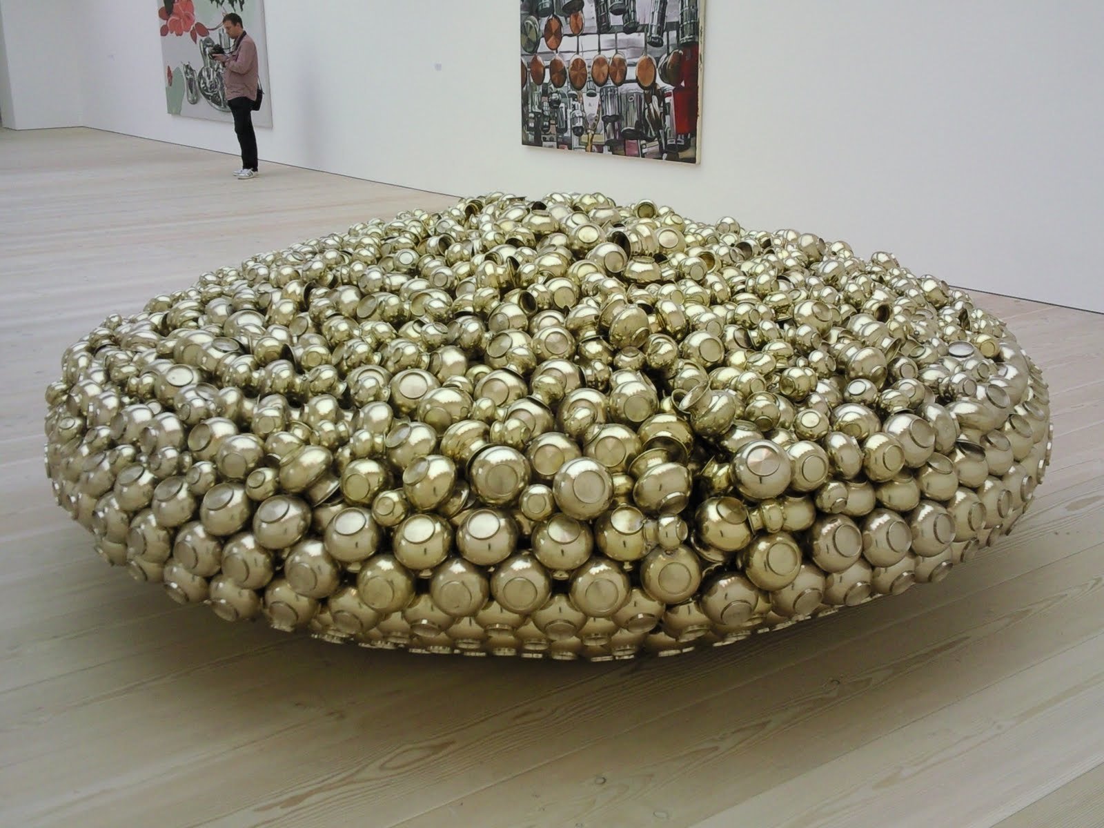 U.F.O (2007) Hundreds of brass water utensils that are soldered together to resemble a flying saucer, 114 x 305 x 305 cm