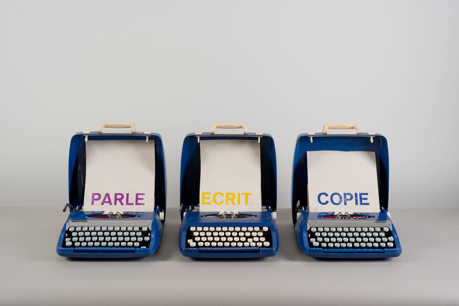 Marcel BroodthaersParle Ecrit Copie, 1972&ndash;1973(Talks, Writes, Copies)Three typewriters, letterpress on canvas34 &times; 31.5 &times; 38 cm (each)&copy; Estate Marcel Broodthaers