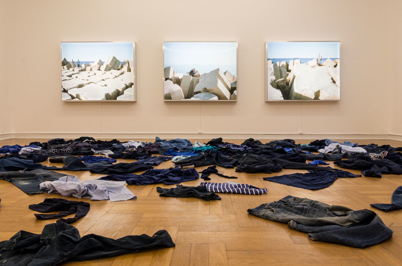 Kader Attia La Mer Morte, 2015 Installation. Clothes and 3 lightboxes, each 130 &times; 160 &times; 18 cmExhibition view, Against the Current: Journey into the Unknown, Museum Schloss Morsbroich, Leverkusen, 2018Photo: Riccardo FranchellucciCourtesy of the artist